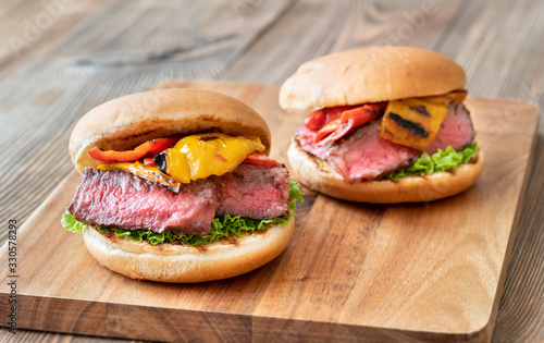 Burgers with grilled steak and bell peppers