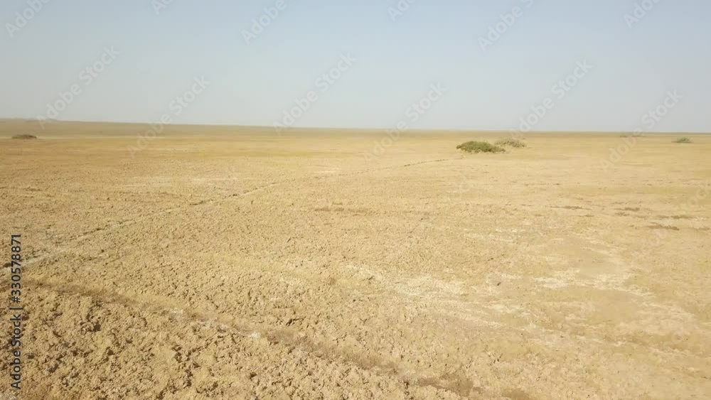 Panoramic top view of the Maranjob desert. A drone flies over the sands and dunes. Visible salt,  Wheel marks and Traces of camels on sand
