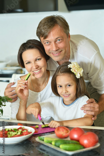 Portrait of family cooking together at kitchen table