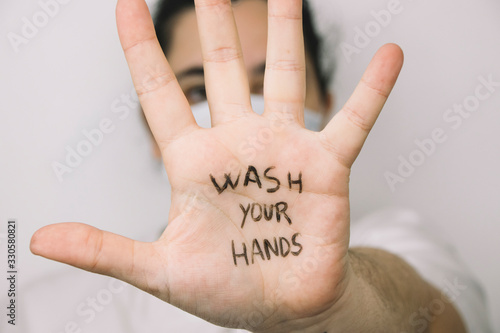 Woman wearing a safety mask with hand opened with the sentence 