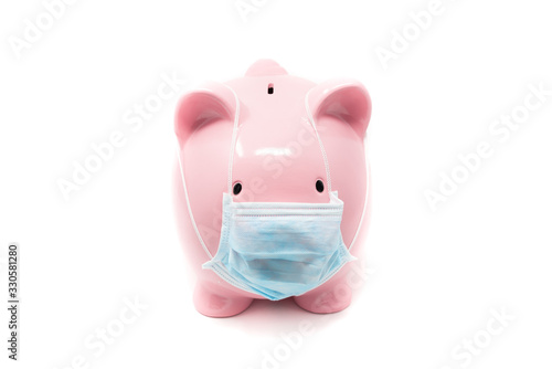 Piggybank wearing surgery mask; concept of the impact of a pandemia in Economy photo