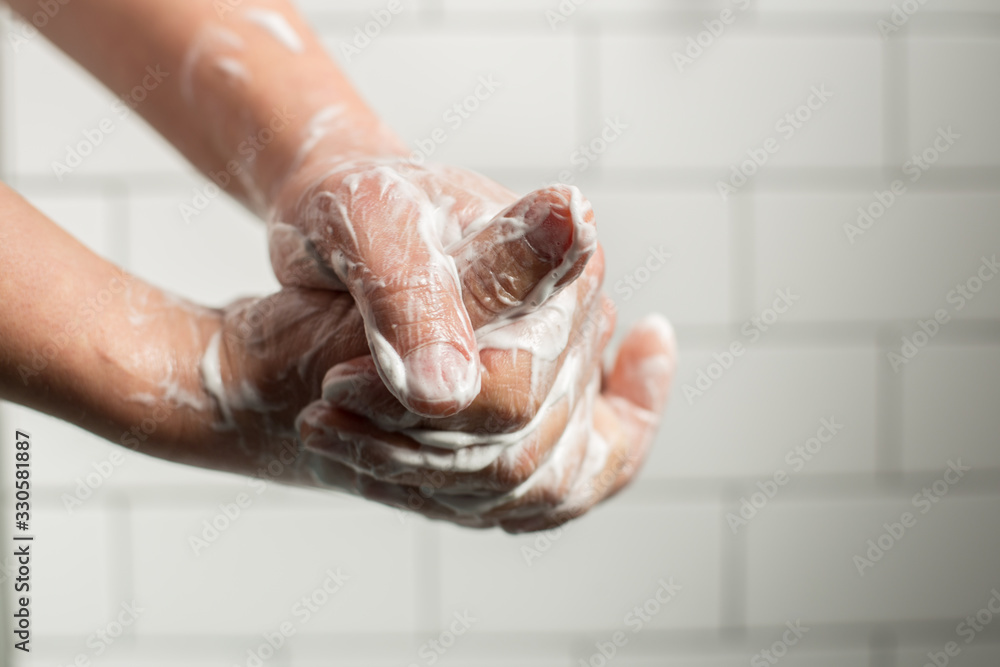 Fototapeta premium A man washing hands with soap. Preventing spreading virus concept.