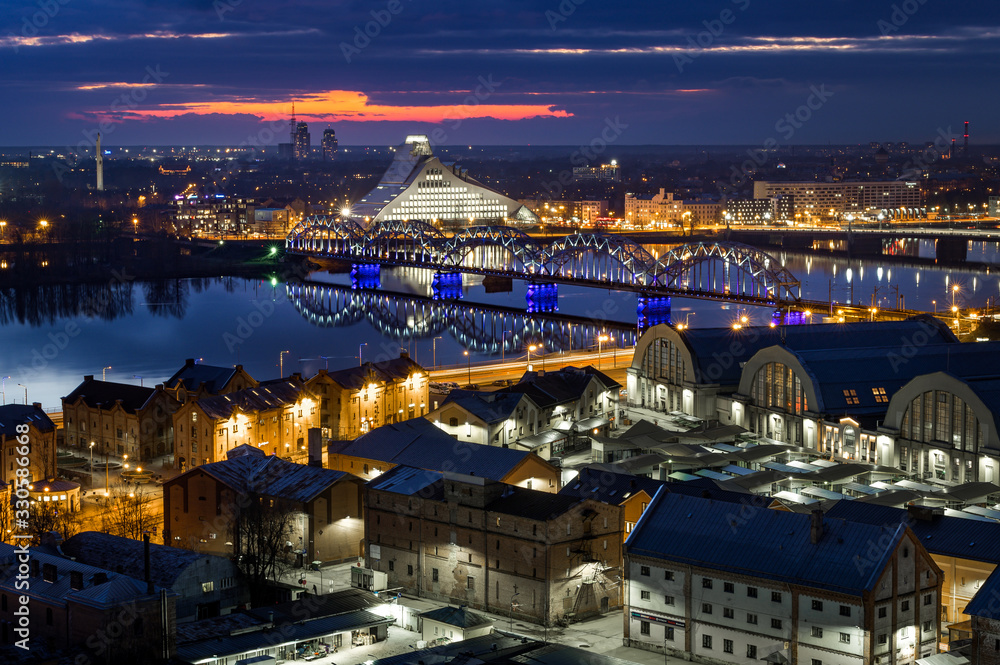 Obraz premium Panoramic, aerial view over Riga city. Scenic view over iconic church towers, old town and infrastructure.