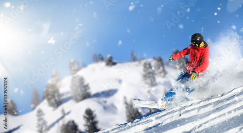 Young snowboarder is jumping with snowboard from snowhill in deep fresh snow.Crazy or madness free ride on winter slope.
