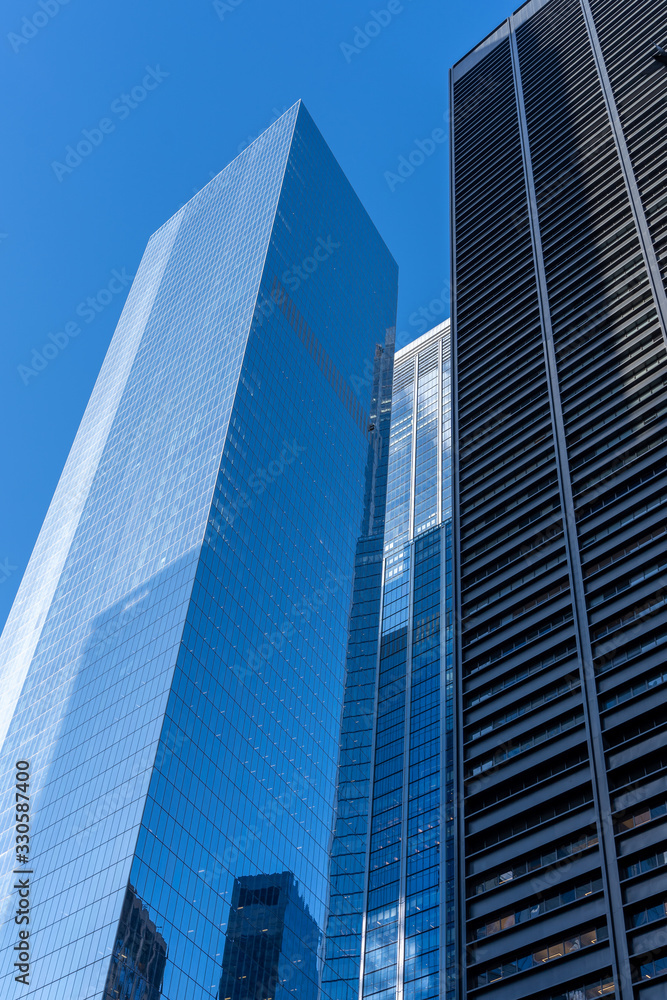 Reflections of the clouds on a glass skyscraper in new york city, scenic view from below