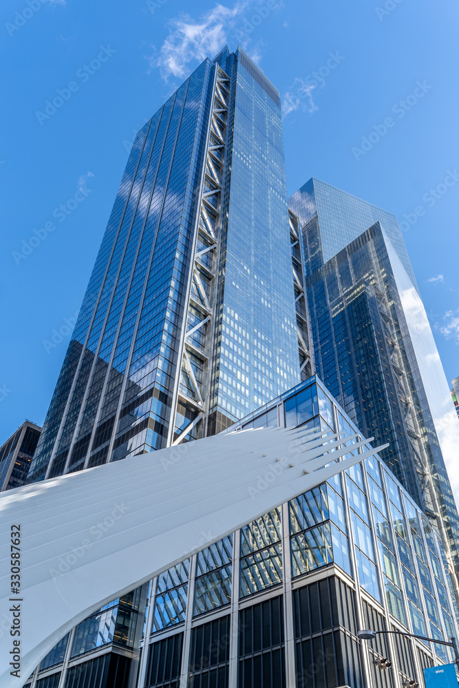 Reflections of the clouds on a glass skyscraper in new york city, scenic view from below