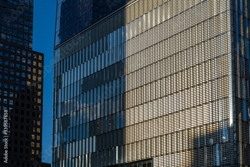 detail of the freedom tower one world trade center, glass skyscraper reflecting clouds detail in wal street, manhattan, new york city NYC