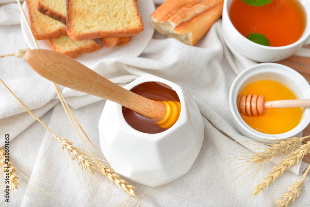 Tasty honey with bread and tea on table Tasty honey with bread and tea on table