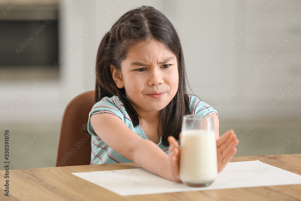 Cute Asian girl with dairy allergy at home Cute Asian girl with dairy allergy at home