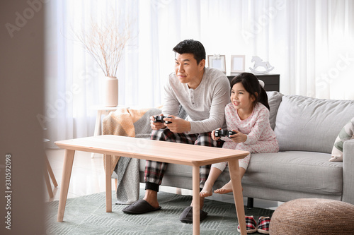 Asian man and his little da...