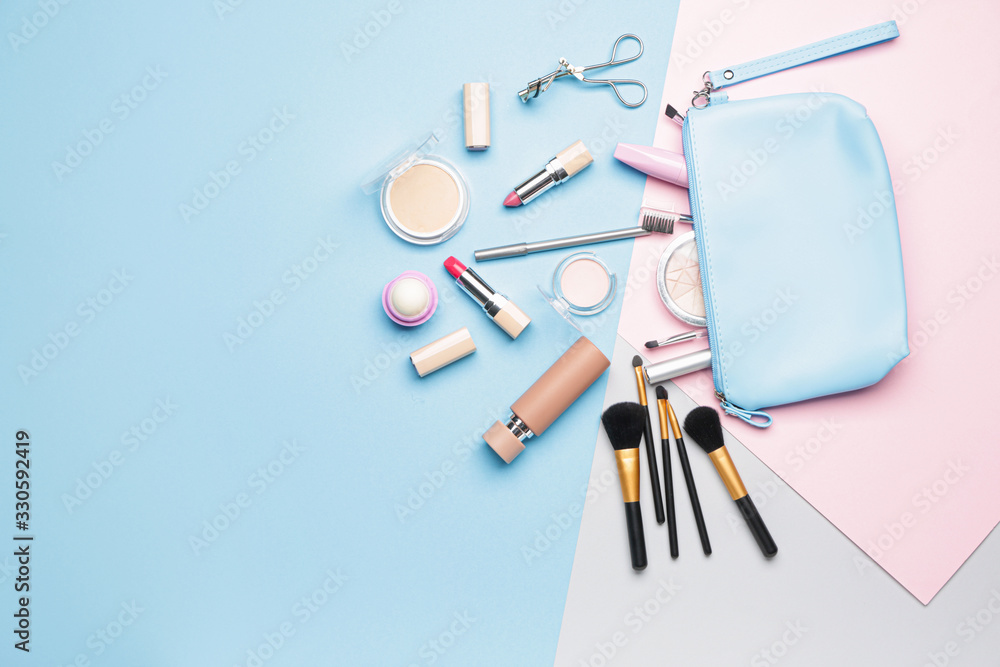 Bag with makeup accessories and decorative cosmetics on color background Bag with makeup accessories and decorative cosmetics on color background