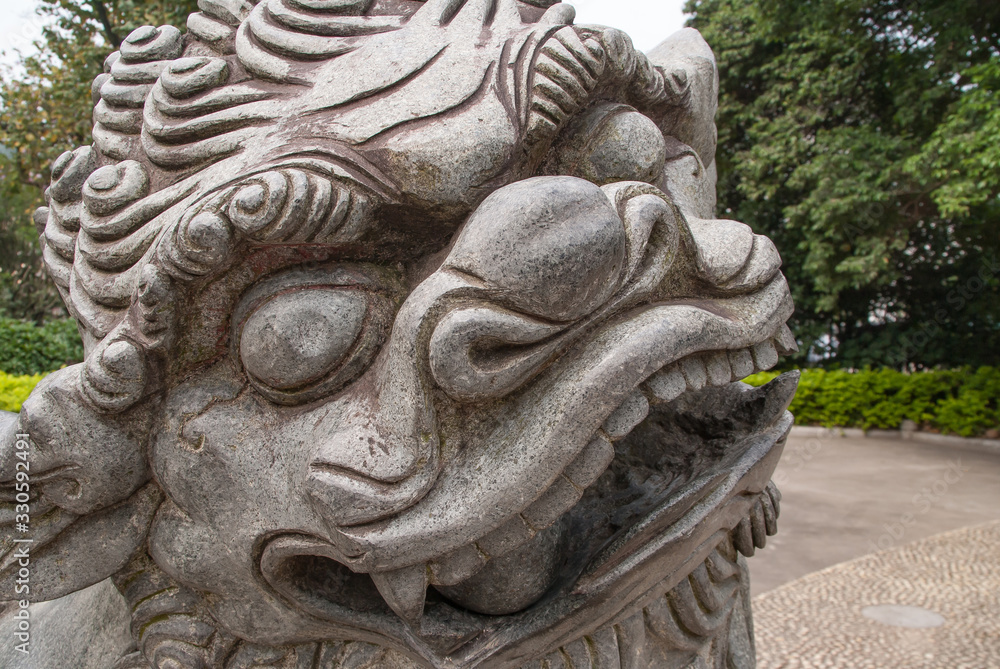 Closeup of face of Chinese mythological lion in Seven Star Park, Guilin, China.
