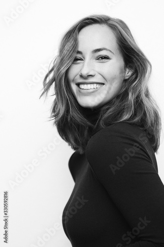 Fotobehang Black and white portrait of a young happy woman with a big smile on her face