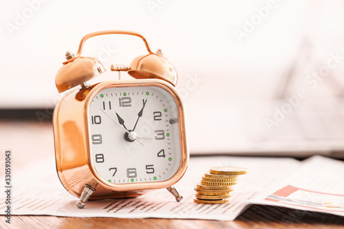 Alarm clock and money on ta...