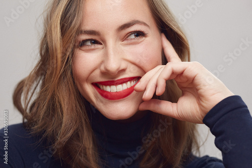 Portrait of a happy and beautiful woman with a big smile on her face thinking and being thoughtful photo