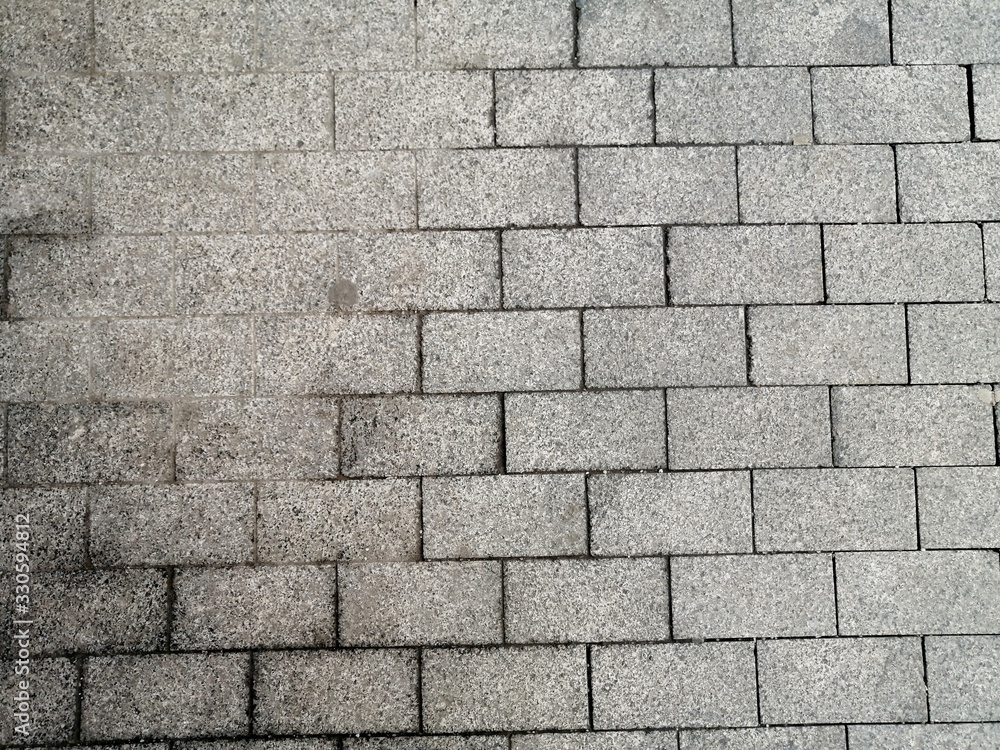 Fototapeta premium grey granite tiles are laid on the streets of the city