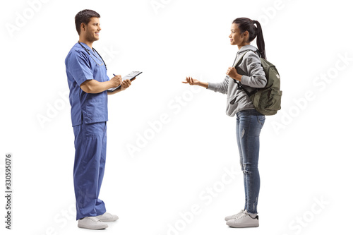 Female student taking to a doctor in a blue uniform