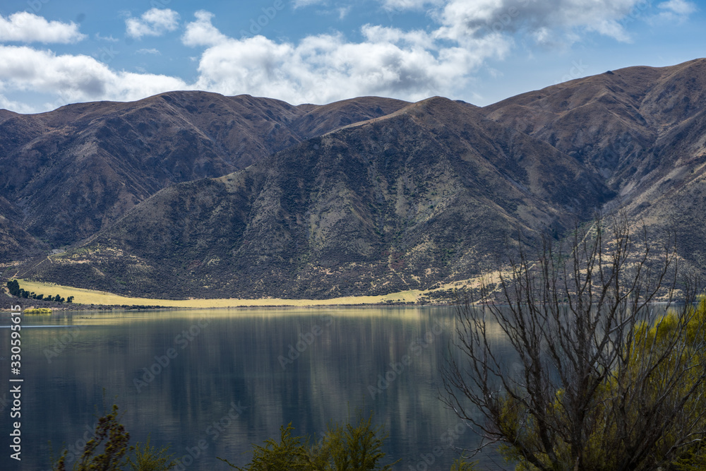 Beautiful lake with mountains reflected in the water taken on a sunny day, New Zealand