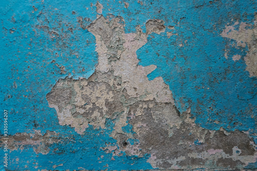 Old blue paint peeling on concrete wall, abstract background, Selective focus Old blue paint peeling on concrete wall, abstract background, Selective focus