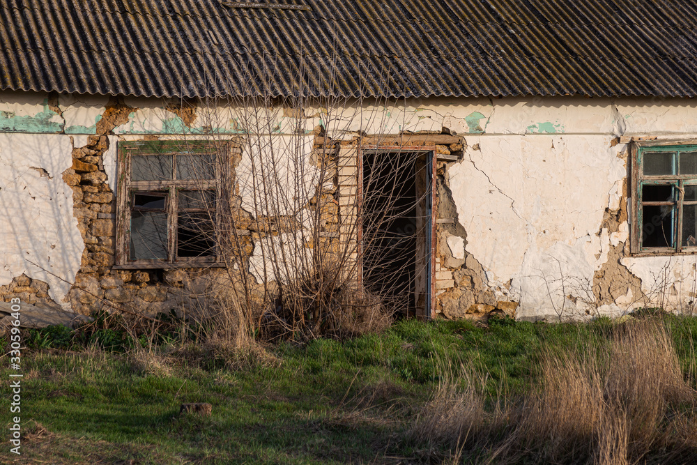 Old abandoned building with ruined windows and walls. Huge large cracks in old brick wall. Abandoned house not needed. Devastation after earthquake. Apocalypse Old abandoned building with ruined windows and walls. Huge large cracks in old brick wall. Abandoned house not needed. Devastation after earthquake. Apocalypse