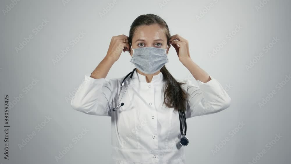 Doctor puts on a medical mask