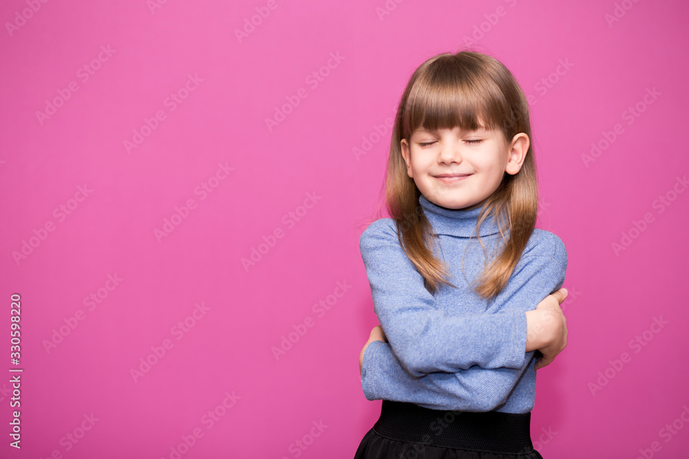 Cute little girl hugs herself, smiling carefree and happy. Cute little girl hugs herself, smiling carefree and happy.