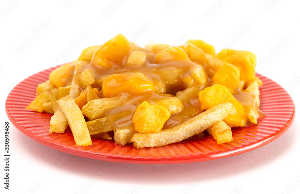 Plate of Poutine with Orange Cheddar Cheese with Brown Gravy on French Fries Plate of Poutine with Orange Cheddar Cheese with Brown Gravy on French Fries