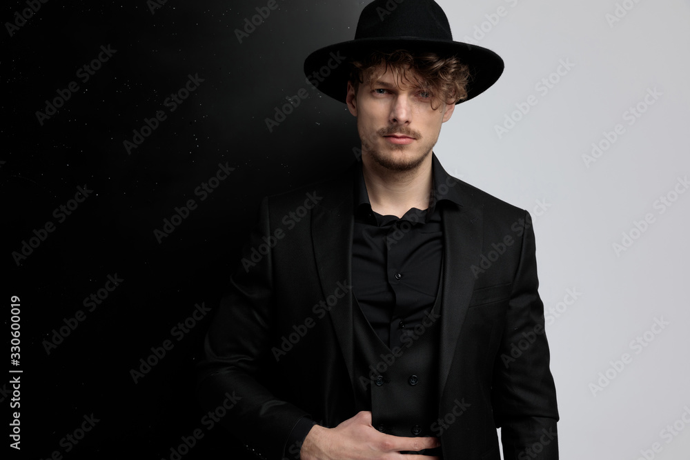 Confident fashion model adjusting his vest Confident fashion model adjusting his vest