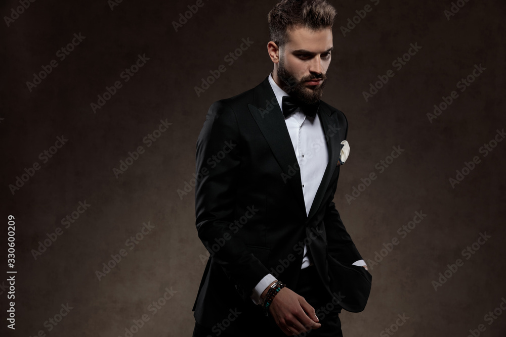 Eager fashion groom looking curiously while wearing suit Eager fashion groom looking curiously while wearing suit