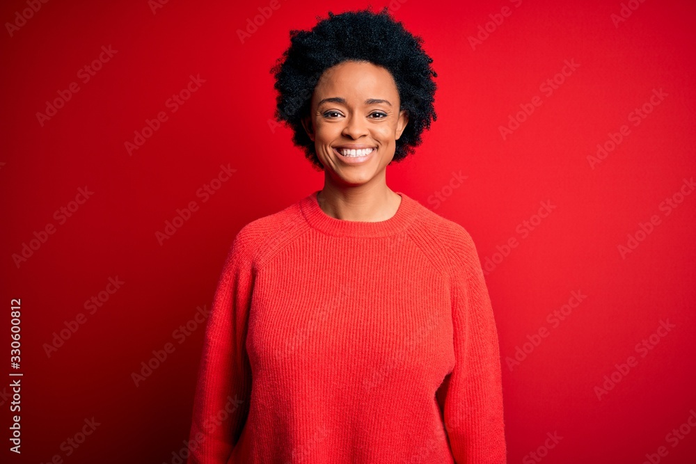 Young beautiful African American afro woman with curly hair wearing casual sweater with a happy and cool smile on face. Lucky person. Young beautiful African American afro woman with curly hair wearing casual sweater with a happy and cool smile on face. Lucky person.