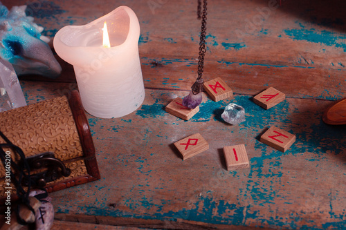 Fortune telling with a pendulum and runes