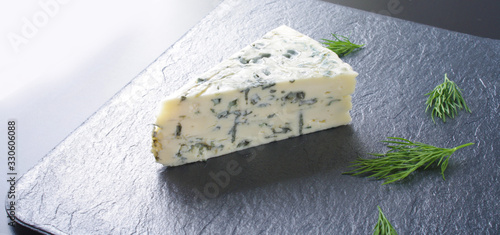 blue cheeseon a dark stone background photo