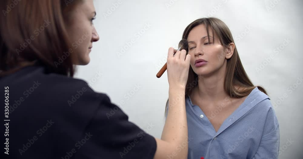 professional makeup artist applying makeup on model professional makeup artist applying makeup on model