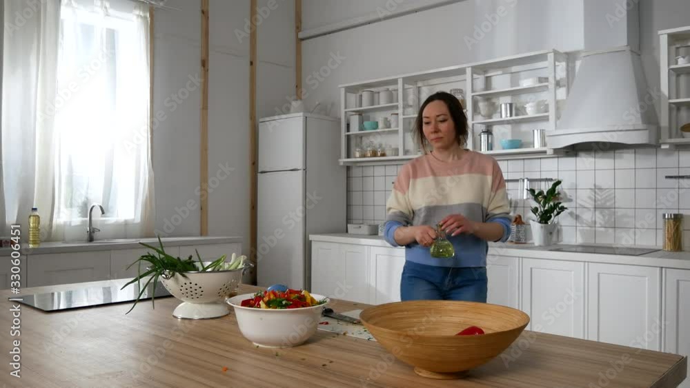 girl in the kitchen preparing a salad girl in the kitchen preparing a salad