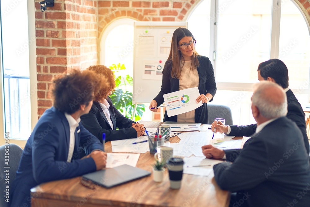 Group of business workers working together in a meeting. Listening one of them speaking at the office. Group of business workers working together in a meeting. Listening one of them speaking at the office.