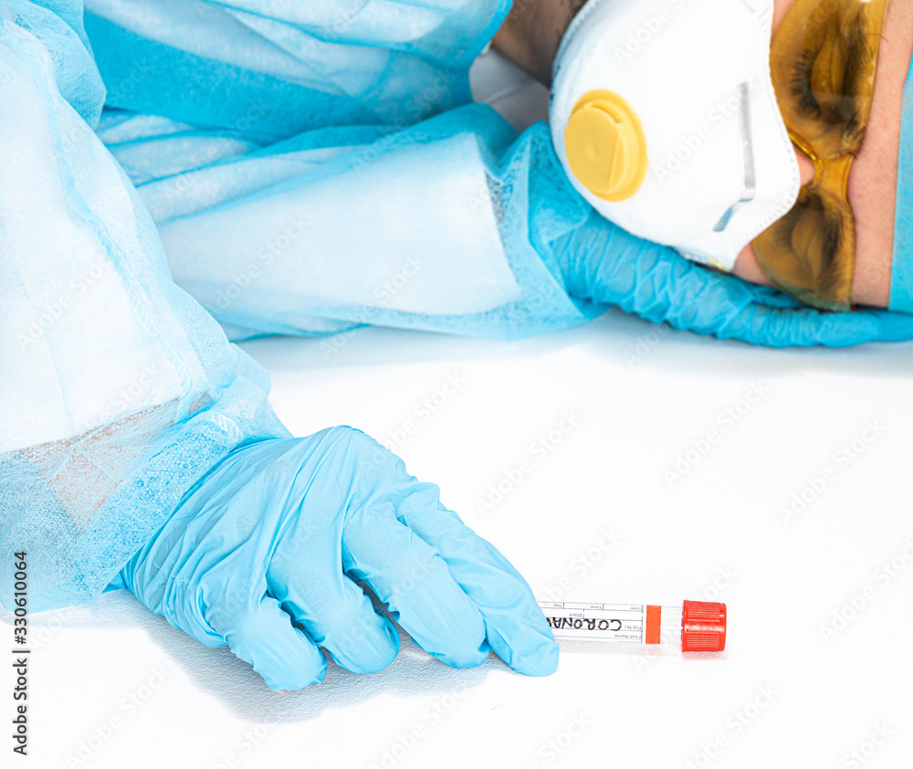 Fototapeta premium An exhausted doctor rests after hard work with coronavirus. The concept of fighting the coronavirus epidemic, COVID 19. Attempt to eliminate the SARS pandemic. Fighting the world against epidemics.