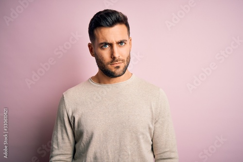 Young handsome man wearing casual sweater standing over isolated pink background skeptic and nervous, frowning upset because of problem. Negative person. © Krakenimages.com