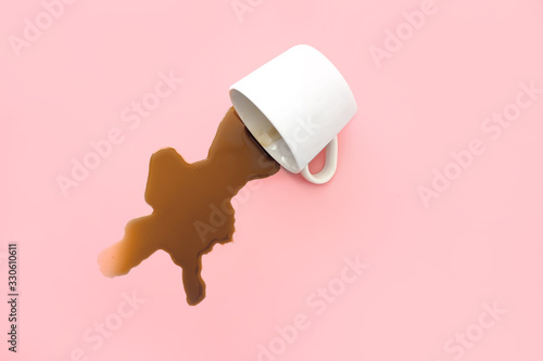 Tableau sur toile Overturned cup of coffee on color background