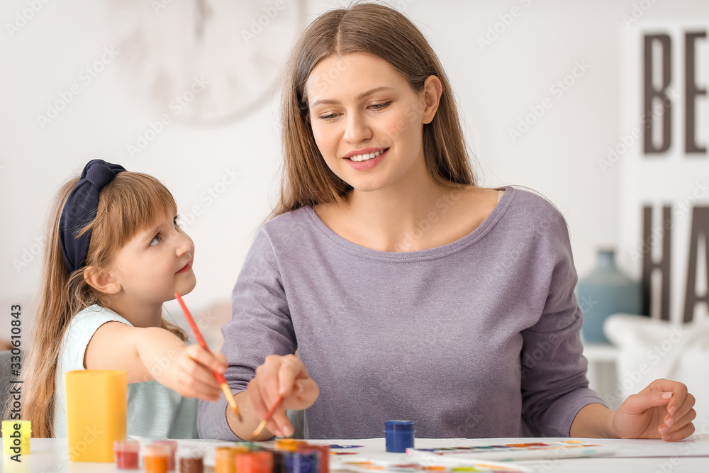 Drawing teacher giving private art lessons to little girl at home Drawing teacher giving private art lessons to little girl at home