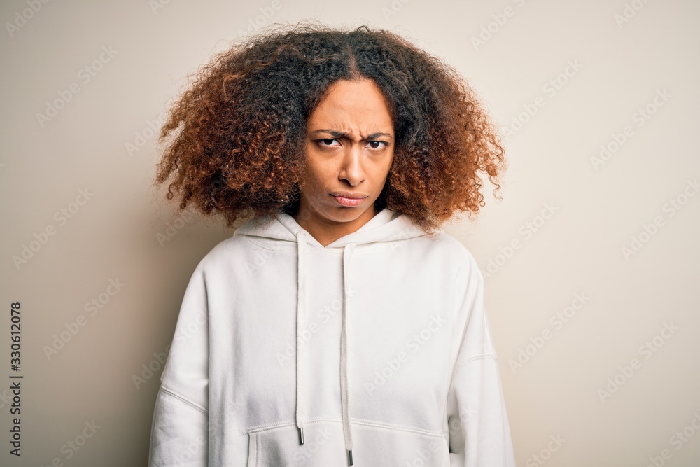 Young african american sportswoman with afro hair wearing sporty sweatshirt skeptic and nervous, frowning upset because of problem. Negative person. Young african american sportswoman with afro hair wearing sporty sweatshirt skeptic and nervous, frowning upset because of problem. Negative person.