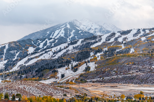 Aspen, Colorado USA city with buttermilk ski slope in rocky mountains view of storm clouds and small airport runway in roaring fork valley