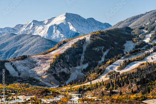 Aspen, Colorado buttermilk or highlands famous ski slope hill peak in rocky mountains view on sunny day with snow on yellow foliage autumn trees photo
