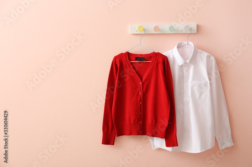 Wallpaper Mural Stylish school uniform hanging on color wall Torontodigital.ca