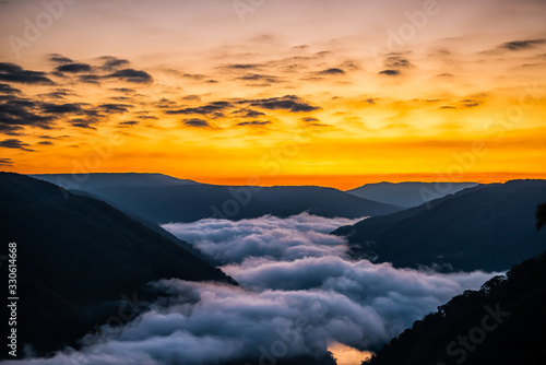 Fototapeta Mountains landscape clouds foggy mist in morning above new river gorge valley in