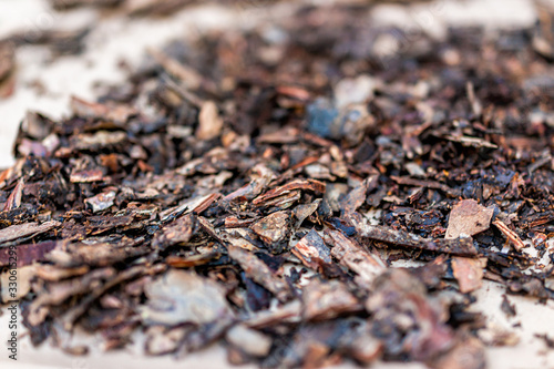 Closeup macro view of wood chips bark peel for gardening mulch for orchids on table showing texture © Kristina Blokhin