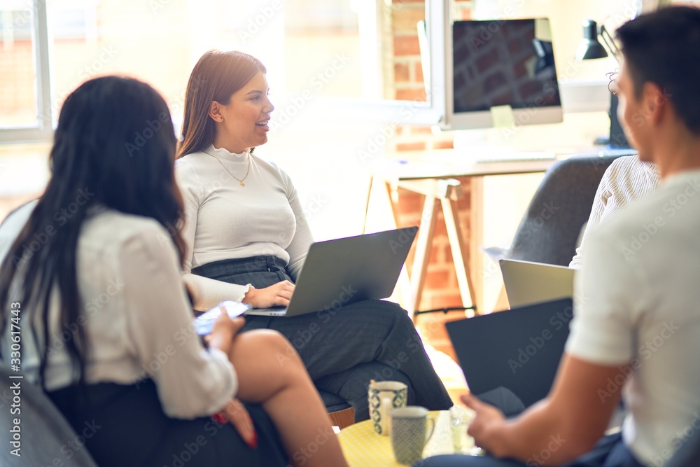 Group of business workers smiling happy and confident. Sitting on chairs relaxed with smile on face. Speaking taking rest at the office Group of business workers smiling happy and confident. Sitting on chairs relaxed with smile on face. Speaking taking rest at the office