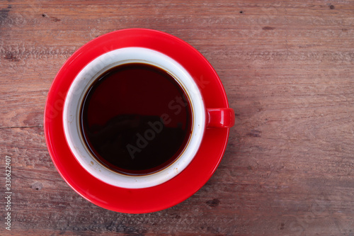 Top view Black coffee in a red coffee cup on a wooden background