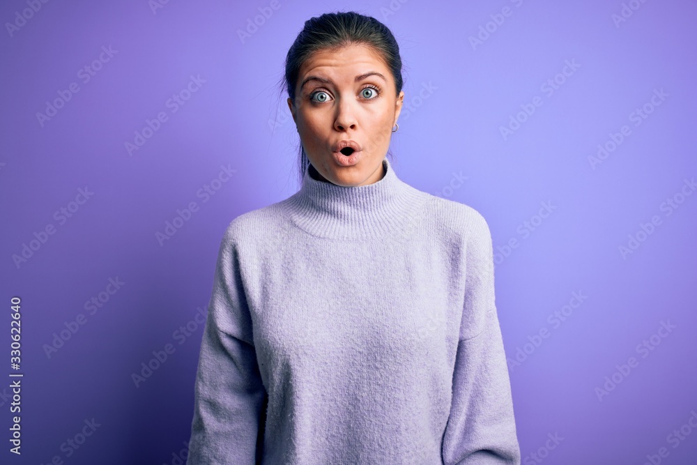 Young beautiful woman with blue eyes wearing casual turtleneck sweater over pink background afraid and shocked with surprise expression, fear and excited face. Young beautiful woman with blue eyes wearing casual turtleneck sweater over pink background afraid and shocked with surprise expression, fear and excited face.