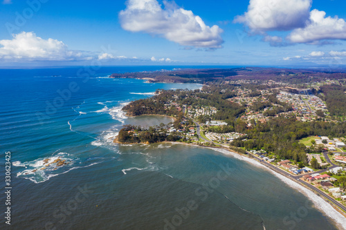Panoramic aerial drone view of Caseys Beach at Batemans Bay on the New South Wales South Coast, Australia, looking out to Tasman Sea on a sunny day 