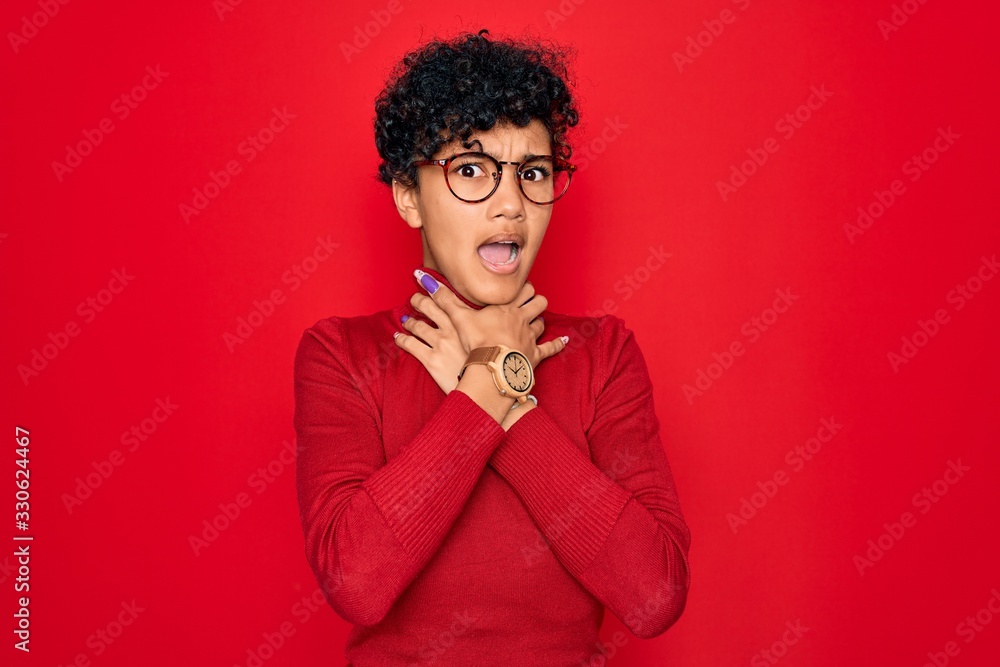 Young beautiful african american afro woman wearing turtleneck sweater and glasses shouting suffocate because painful strangle. Health problem. Asphyxiate and suicide concept.